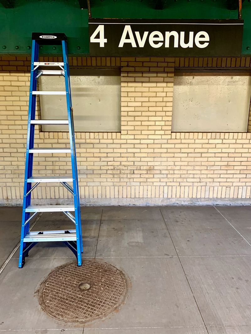 A blue Werner® ladder waiting for the subway at 4th Avenue.