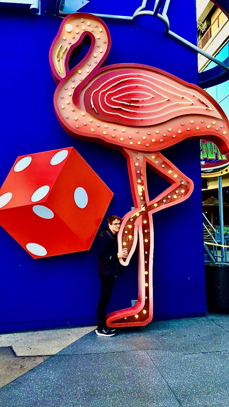 Me hugging a massive neon flamingo you'd only find in Las Vegas.